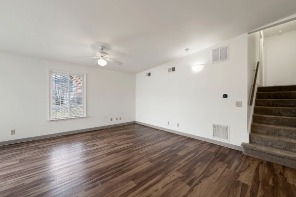 empty living room with hardwood flooring